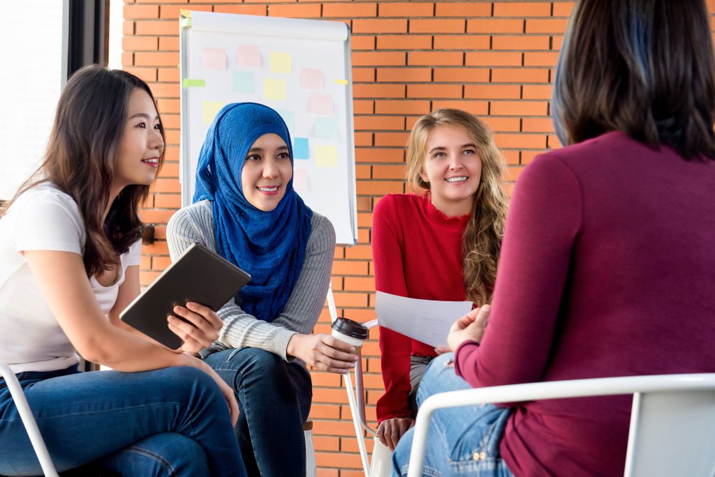 Multicultural women discussing in group